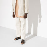 Black Birkenstock Arizona sandals worn by model in white outfit