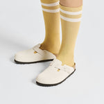 Birkenstock Boston clogs in cream embossed suede worn with yellow striped socks