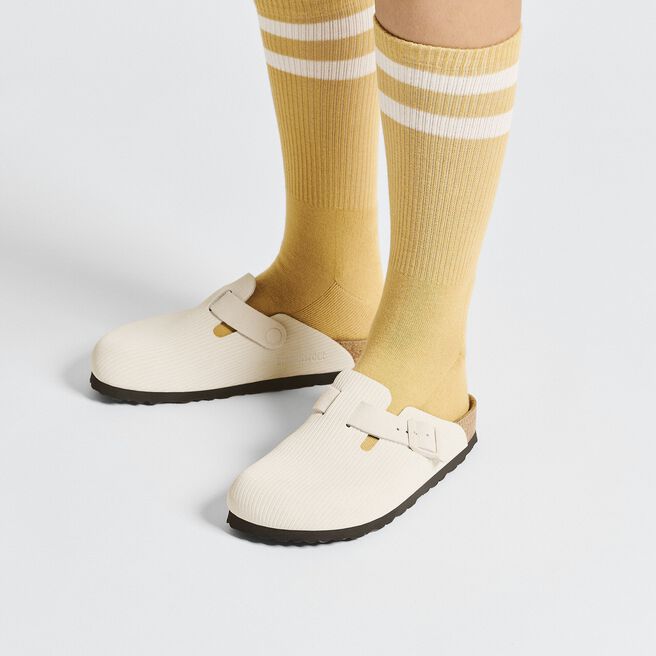 Birkenstock Boston clogs in cream embossed suede worn with yellow striped socks