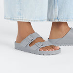 Gray Birkenstock Arizona EVA sandals with two buckle straps on model's feet