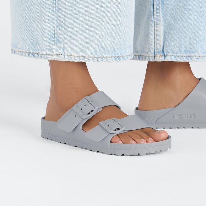 Gray Birkenstock Arizona EVA sandals with two buckle straps on model's feet