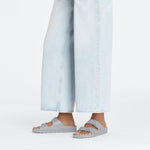 Light gray Birkenstock Arizona EVA sandals worn with light blue jeans