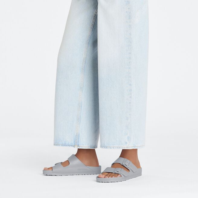 Light gray Birkenstock Arizona EVA sandals worn with light blue jeans