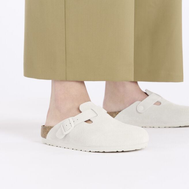 Birkenstock Boston clogs in antique white suede on model's feet