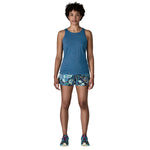 Woman wearing blue heathered tank top and floral shorts in studio photo