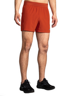 Brooks Sherpa 5 inch running shorts in red clay color on male model