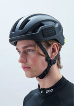 POC Omne Ultra MIPS cycling helmet in uranium black matte worn by cyclist