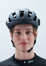 Person wearing POC Omne Ultra MIPS cycling helmet in matte dark gray