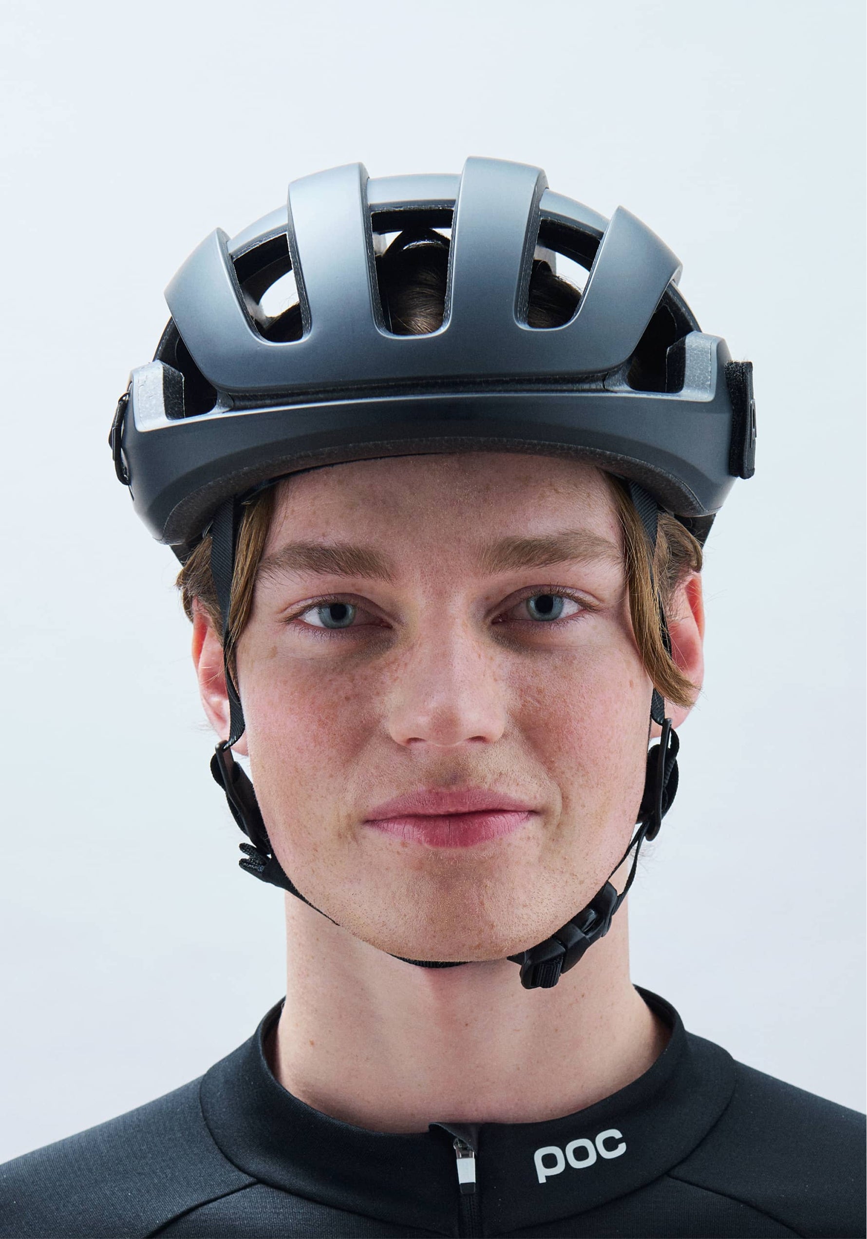 Person wearing POC Omne Ultra MIPS cycling helmet in matte dark gray