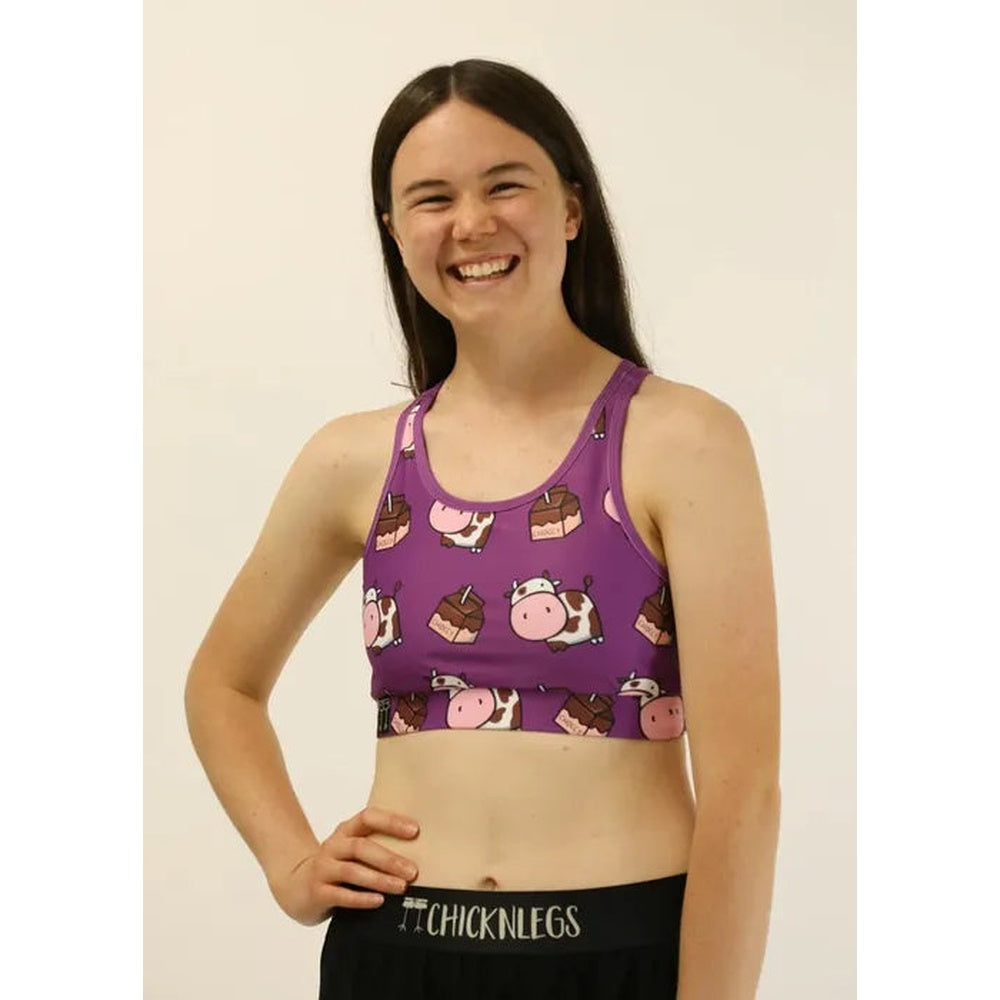 Woman wearing purple sports bra with cute cow print pattern