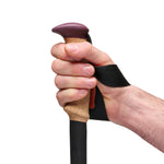 Hand gripping Black Diamond Trail Cork trekking pole with fig-colored ergonomic handle