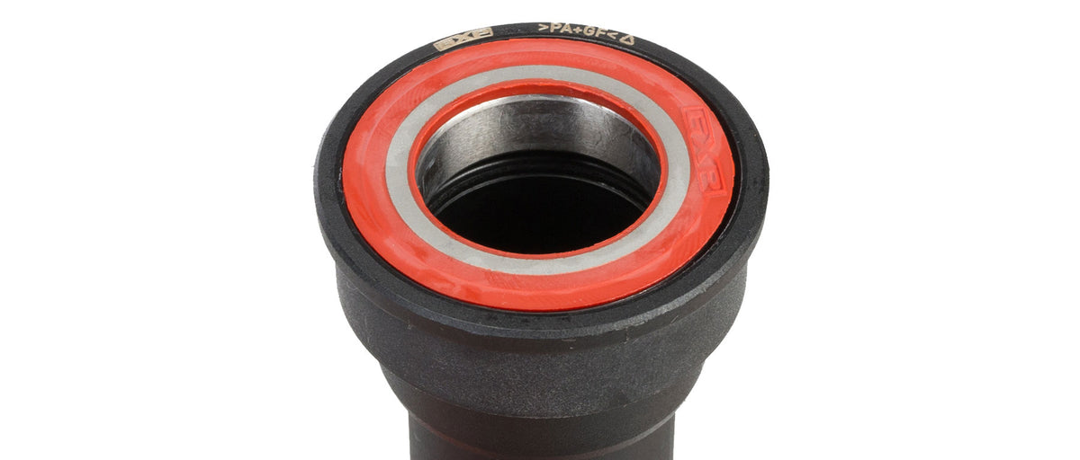 Close-up of SRAM GXP BB86 bottom bracket end showing red sealed bearing and inner race