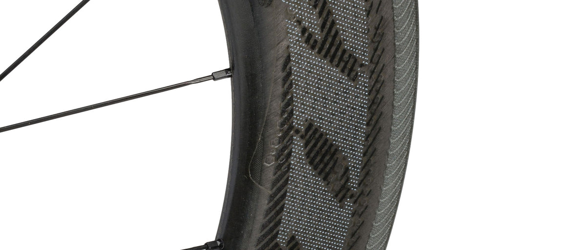 Zipp 808 NSW Carbon Tubeless Disc Wheel closeup showing carbon fiber rim and tire tread