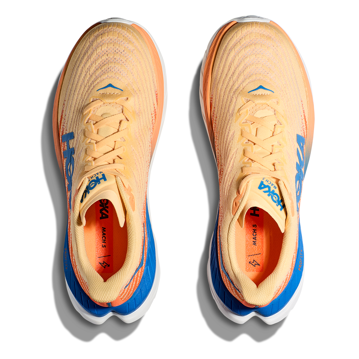 Hoka Mach 5 running shoes in cream and orange colorway with blue accents
