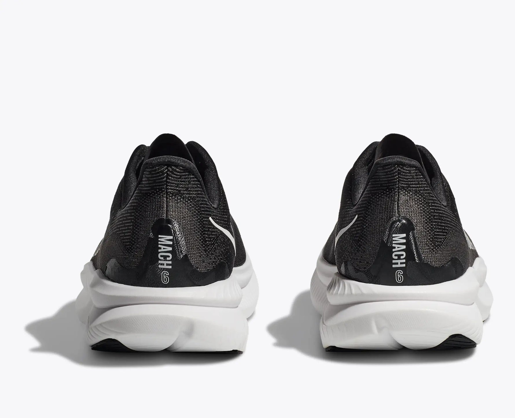 Hoka Mach 6 running shoes in black and dark gray colorway, rear view