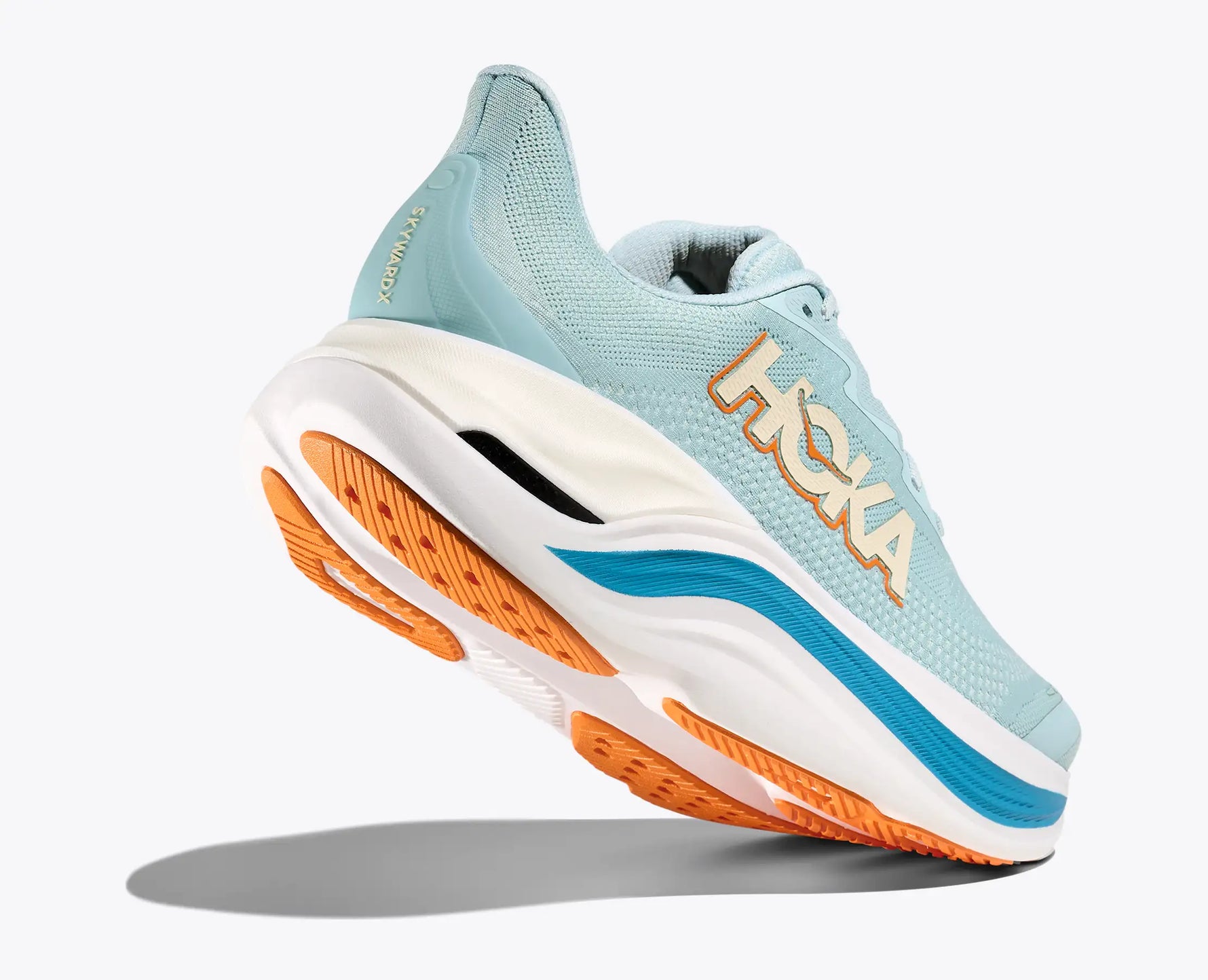 Hoka Skyward X running shoe in lettuce green with white midsole and orange outsole