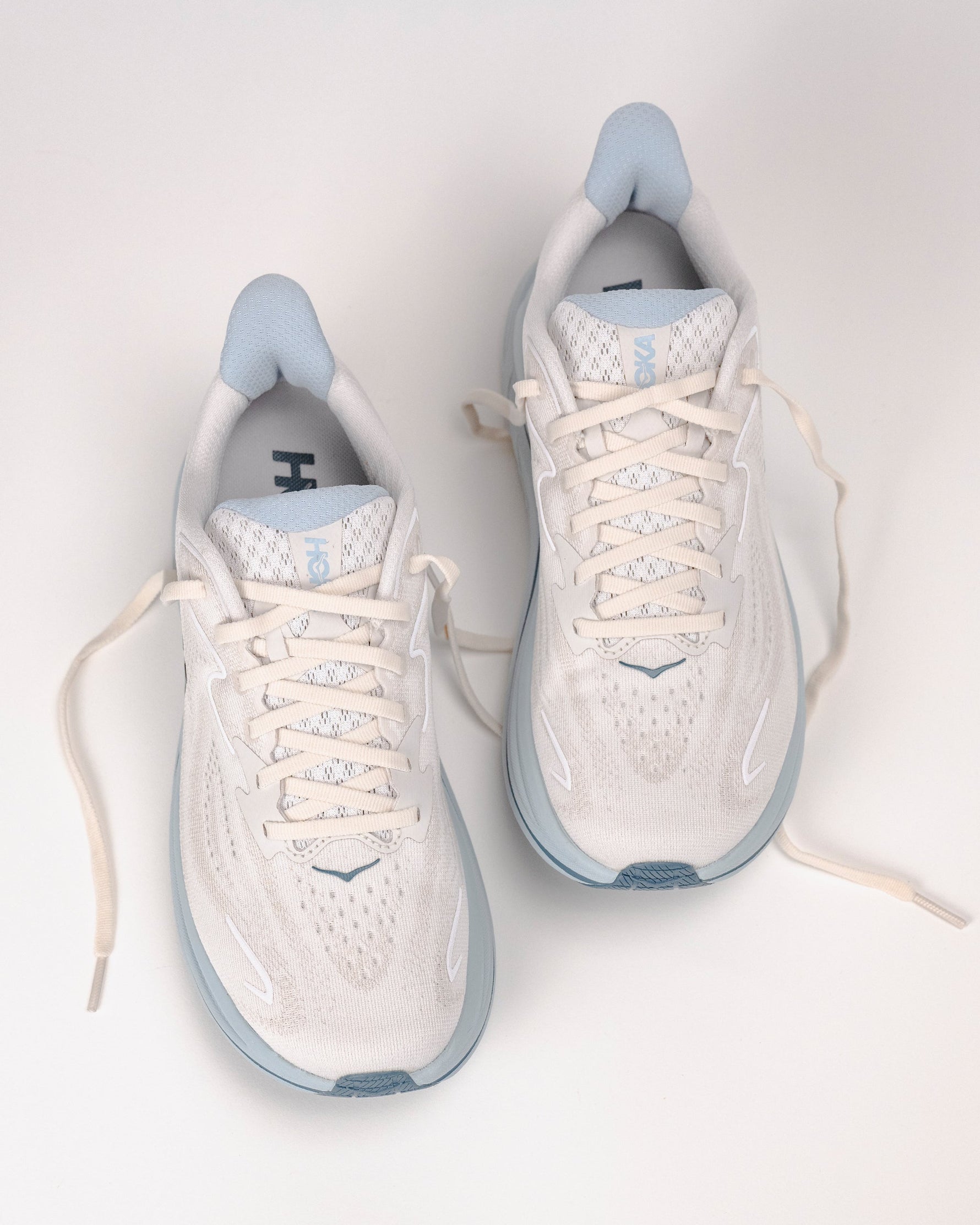 Pair of Hoka Clifton 10 women's running shoes in grout and mineral blue colorway