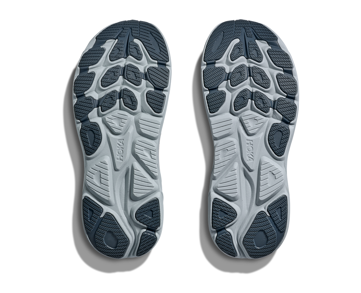 Bottom view of HOKA Clifton 10 women's shoes showing full outsole traction pattern in dark blue