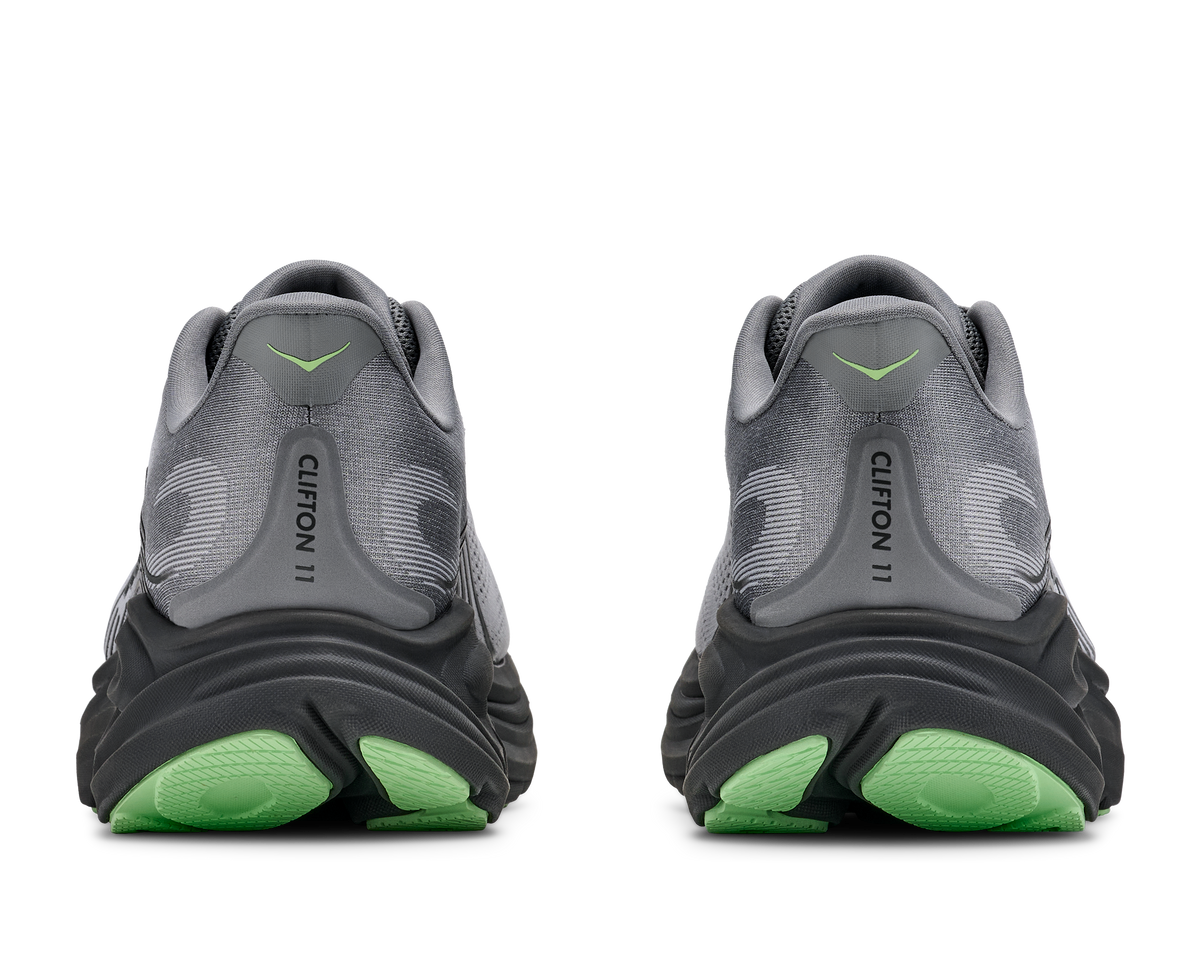 Rear view of pair of HOKA Clifton 11 running shoes showing green outsole and grey heel