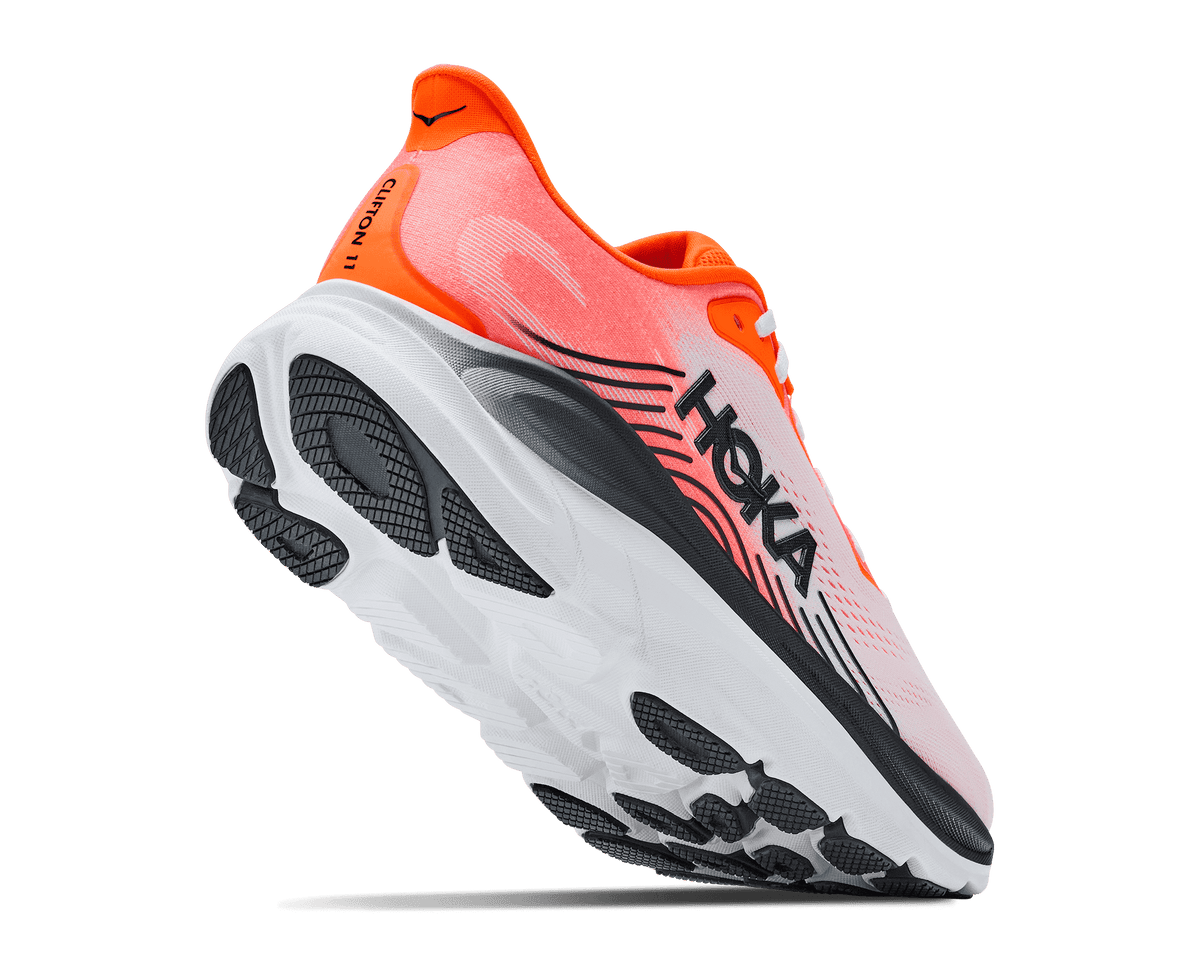HOKA Clifton 11 shoe rear-quarter view showing outsole and neon tangerine heel details