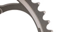 Campagnolo chainring with teeth detail showing dark gray finish and professional studio lighting