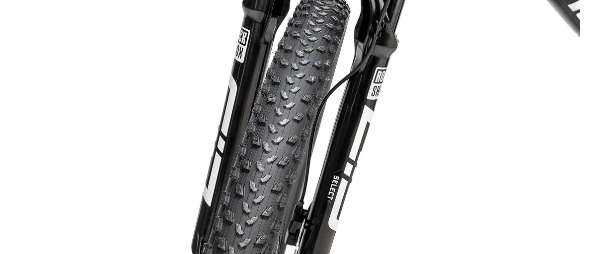 Close-up of RockShox Select+ suspension fork and knobby mountain bike tire on Specialized Epic 9