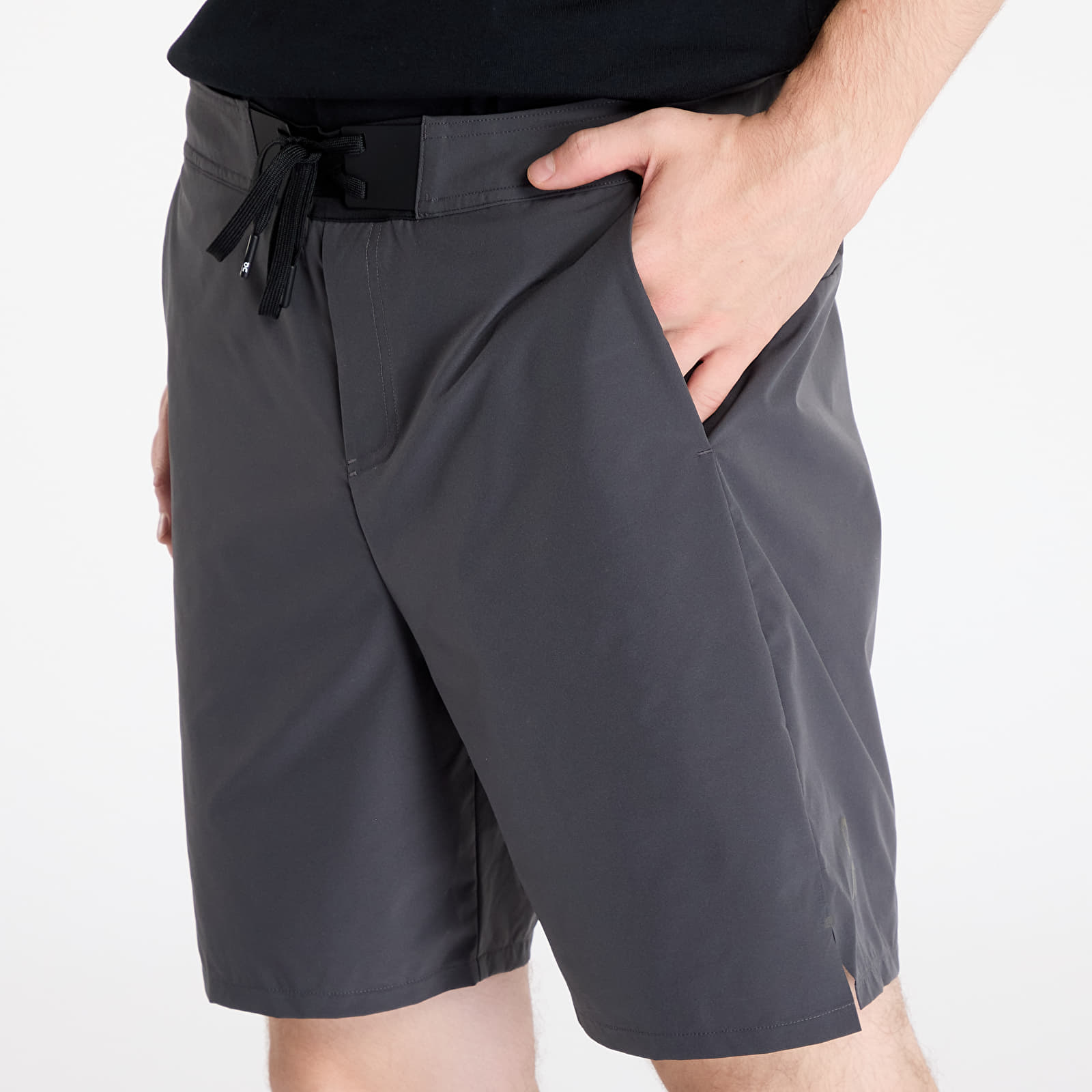 Man wearing On Performance Hybrid Shorts in shadow gray with drawstring waistband