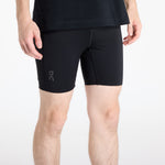 Man wearing black On Performance Hybrid running shorts with logo on thigh