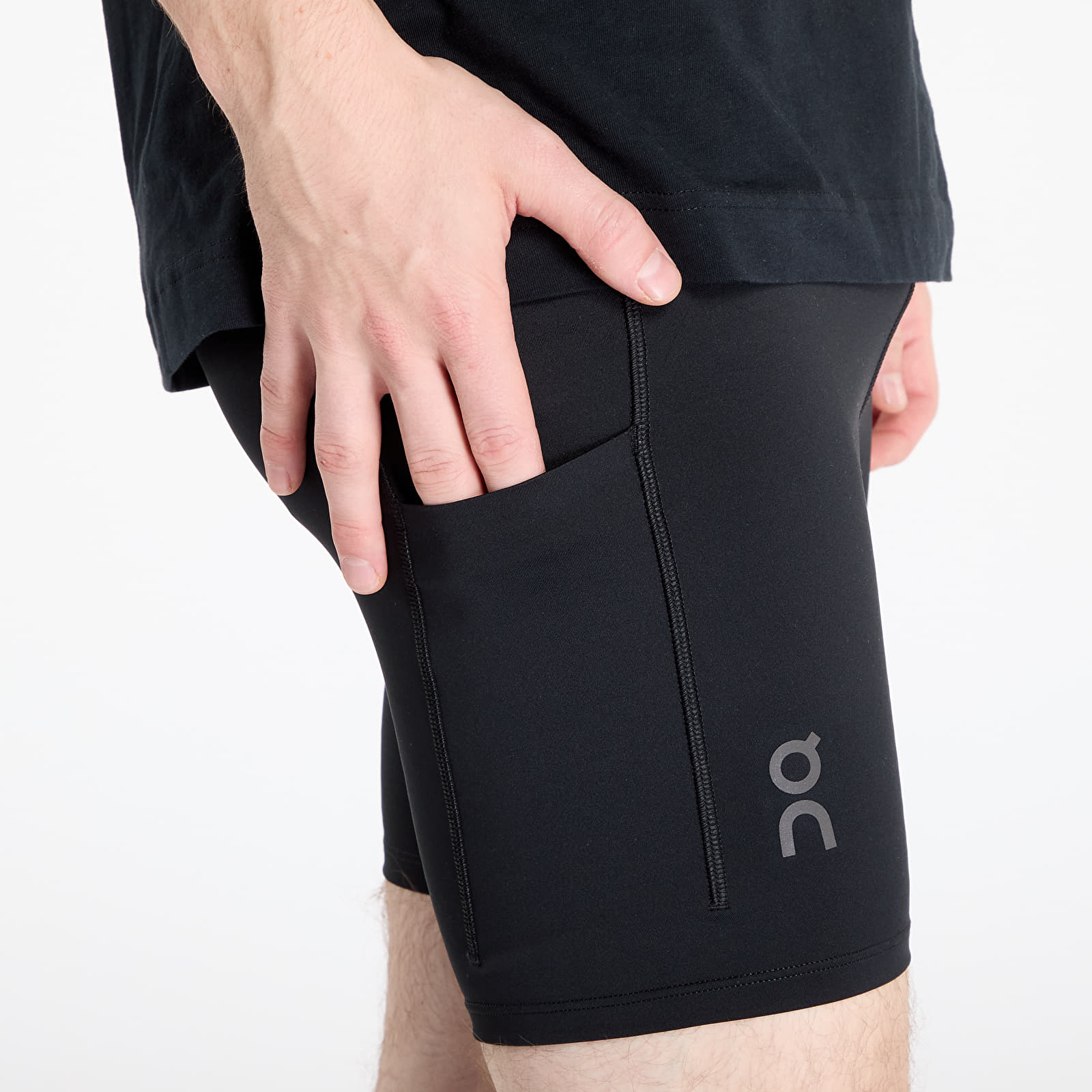 Man wearing black On Performance Hybrid Shorts showing side pocket detail