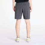 On Performance Hybrid Shorts in shadow gray worn by model, rear view