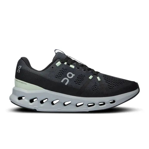 On Cloudsurfer women's running shoe in black with mint accents and signature cloud sole