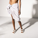 White Birkenstock Arizona Essentials EVA sandals worn by model in studio setting