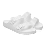 White Birkenstock Arizona Essentials EVA sandals with two adjustable straps on white background