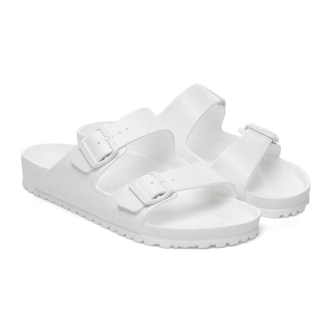 White Birkenstock Arizona Essentials EVA sandals with two adjustable straps on white background