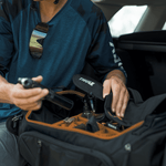 Person packing Thule bike travel bag with orange interior compartments