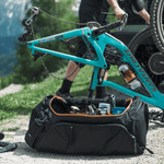 Thule RoundTrip bike duffel bag opened showing interior compartments with bike tools