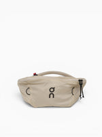 On Waist Pack 2L Lite in cream sand color with rope handle and zipper closure