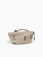 On Waist Pack 2L Lite in cream sand color with rope handle and zipper closure