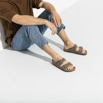 Man wearing Birkenstock Arizona sandals in mocha brown with two-strap design