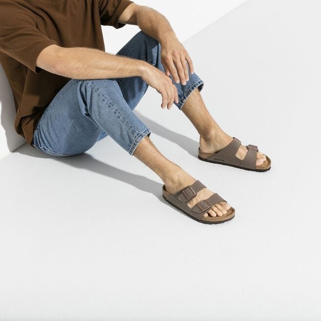 Man wearing Birkenstock Arizona sandals in mocha brown with two-strap design