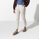 Birkenstock Arizona sandals in mocha brown worn by model with white pants