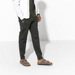 Birkenstock Arizona sandals in mocha brown Birkibuc material on model's feet