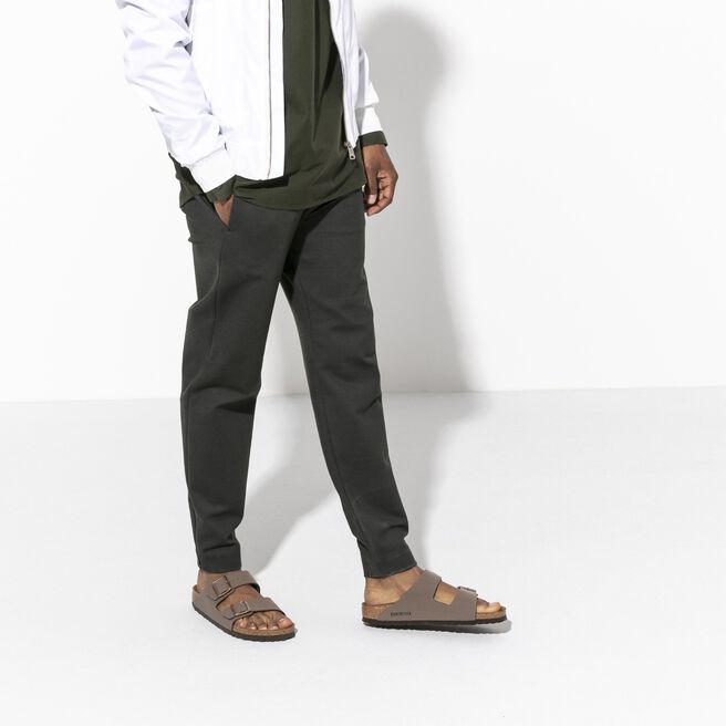 Birkenstock Arizona sandals in mocha brown Birkibuc material on model's feet
