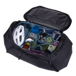 Thule Roundtrip bike duffel bag opened showing organized compartments with cycling gear and helmet