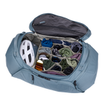 Thule Roundtrip Bike Duffel opened showing organized compartments with cycling gear and helmet