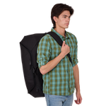 Young man wearing black Thule Roundtrip bike duffel bag on white background