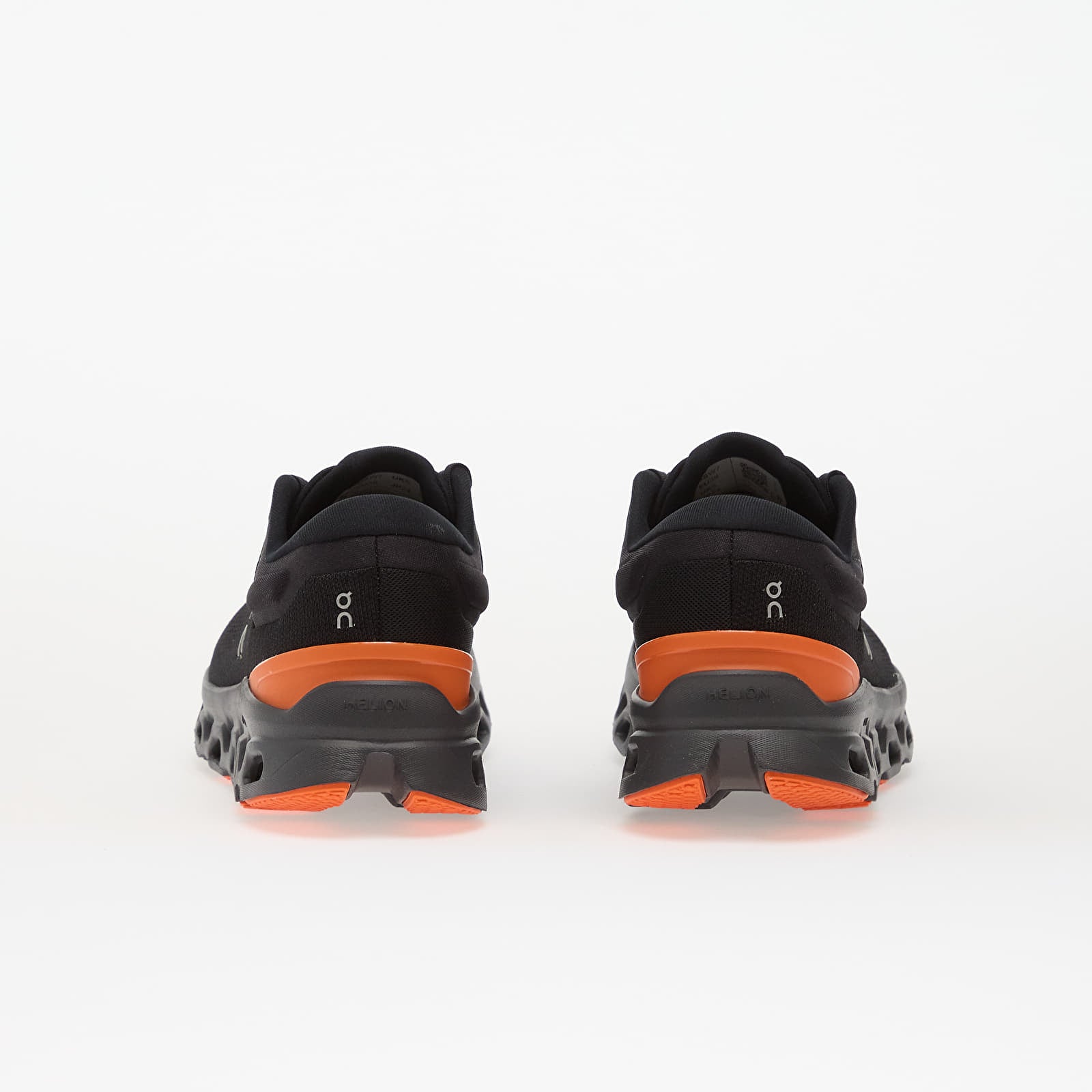 On Cloudstratus 3 running shoes rear view showing black upper with orange midsole details
