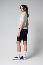 Woman wearing Gobik Phantom Jersey in tofu color with black cycling shorts