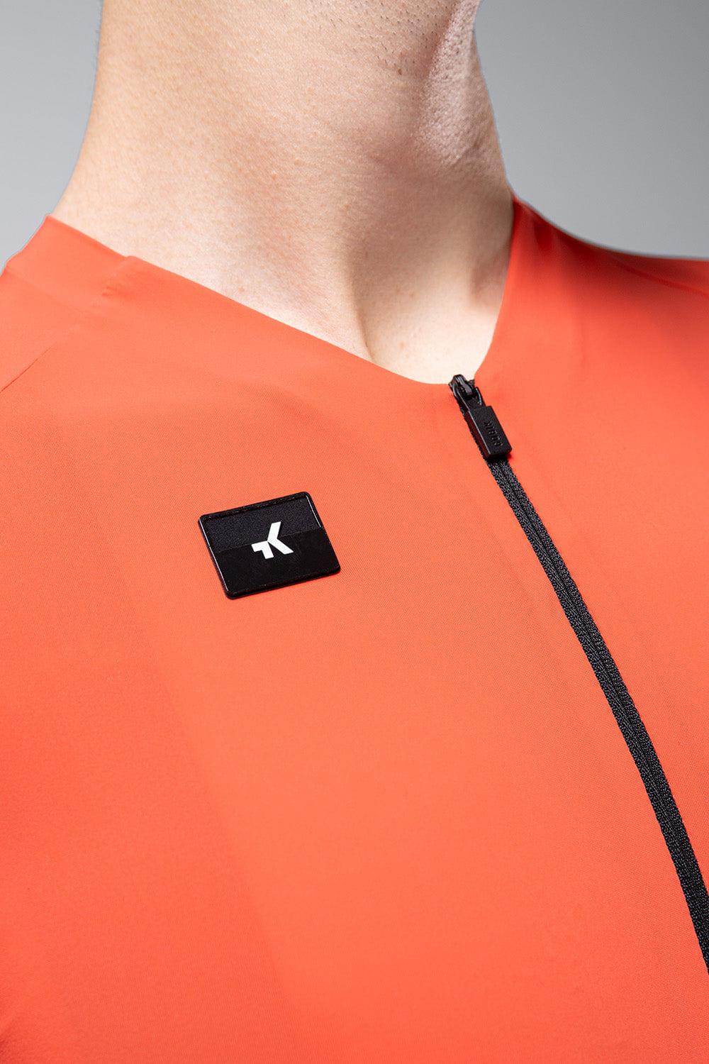 Gobik CX Solid cycling jersey in bright orange with black logo and zipper detail