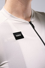 Close-up of white Gobik Infinity cycling jersey showing mesh texture and brand label